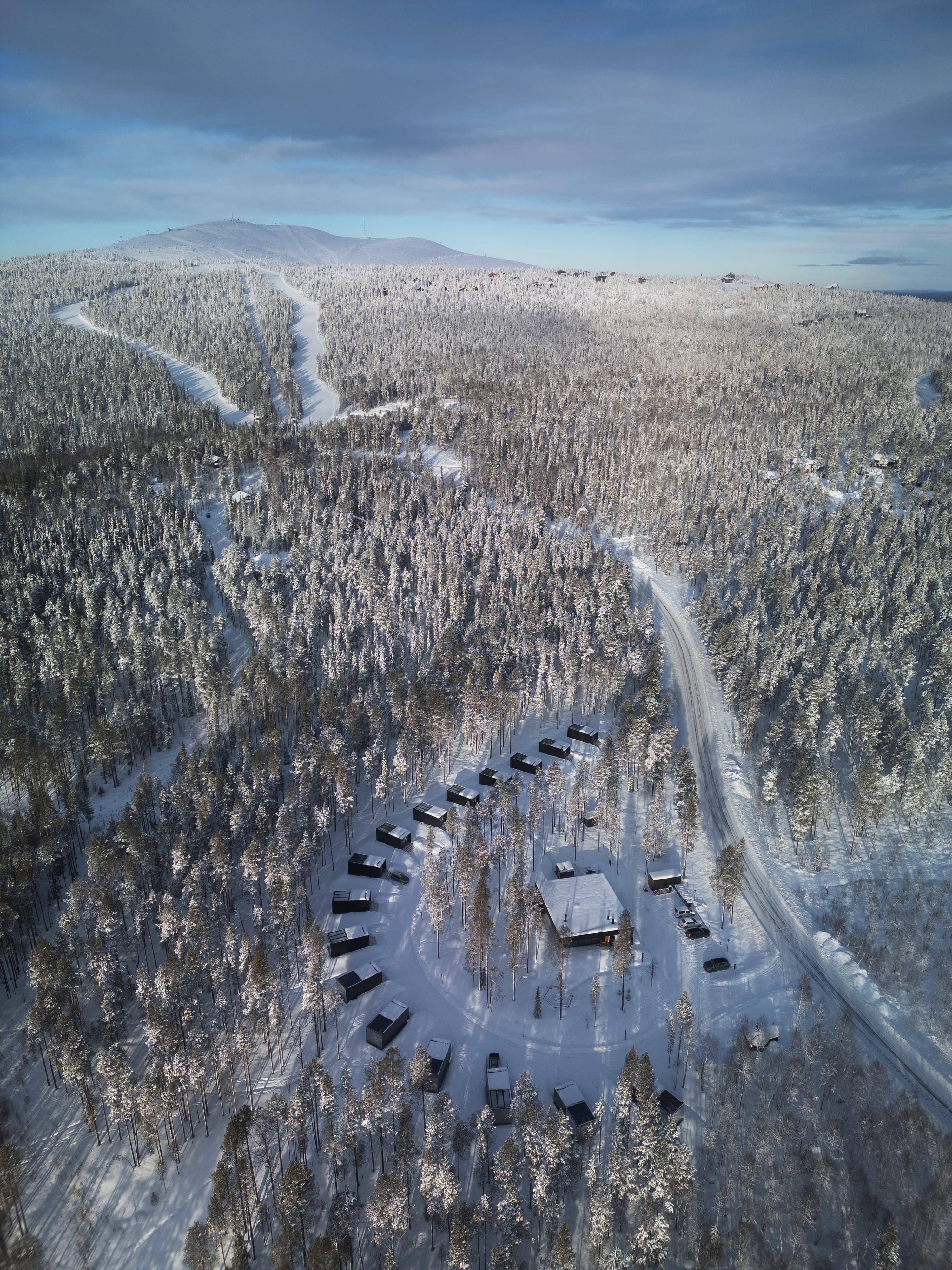 Drone view of glass igloos among the trees at Olo Resort